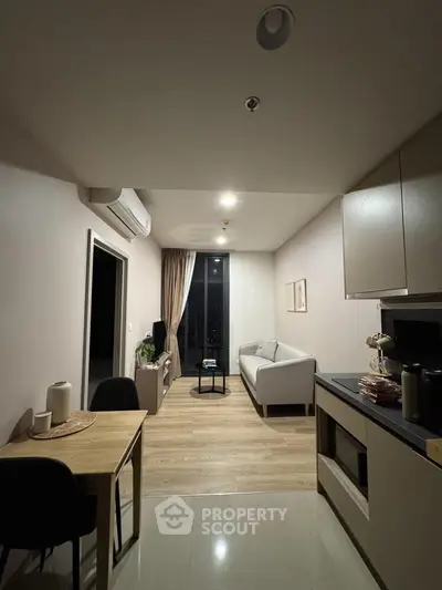 Modern living room with cozy sofa and dining area in open layout apartment