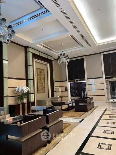 Luxurious building entrance with elegant seating and chandeliers