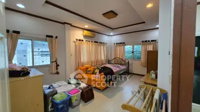 Cozy bedroom with natural light and modern decor, perfect for relaxation.