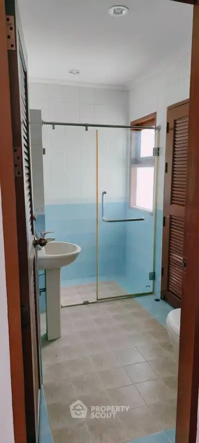 Spacious bathroom with glass shower and modern fixtures