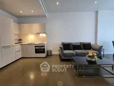 Modern open-plan living room with sleek kitchen and stylish furniture
