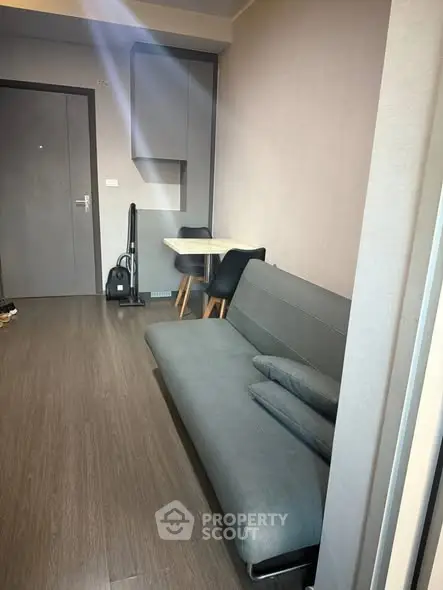 Modern living room with sleek sofa and compact dining area