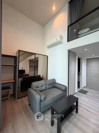 Modern loft-style living room with high ceiling and stylish furniture