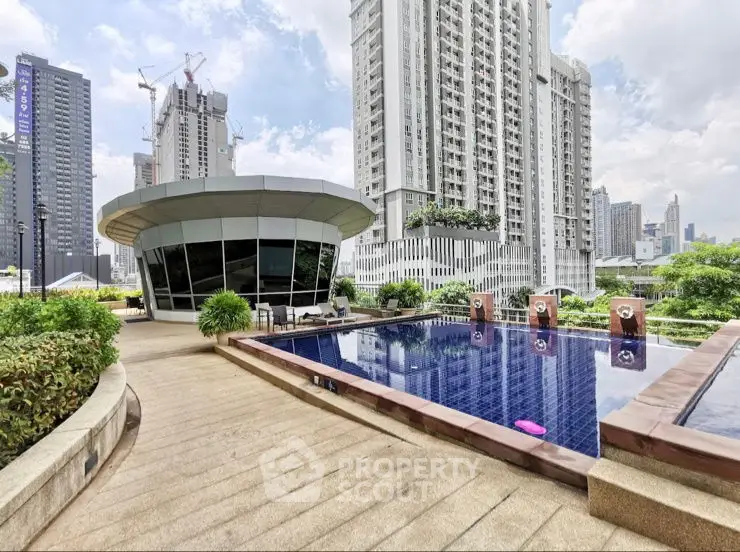 Luxurious rooftop pool with cityscape views in modern high-rise building.