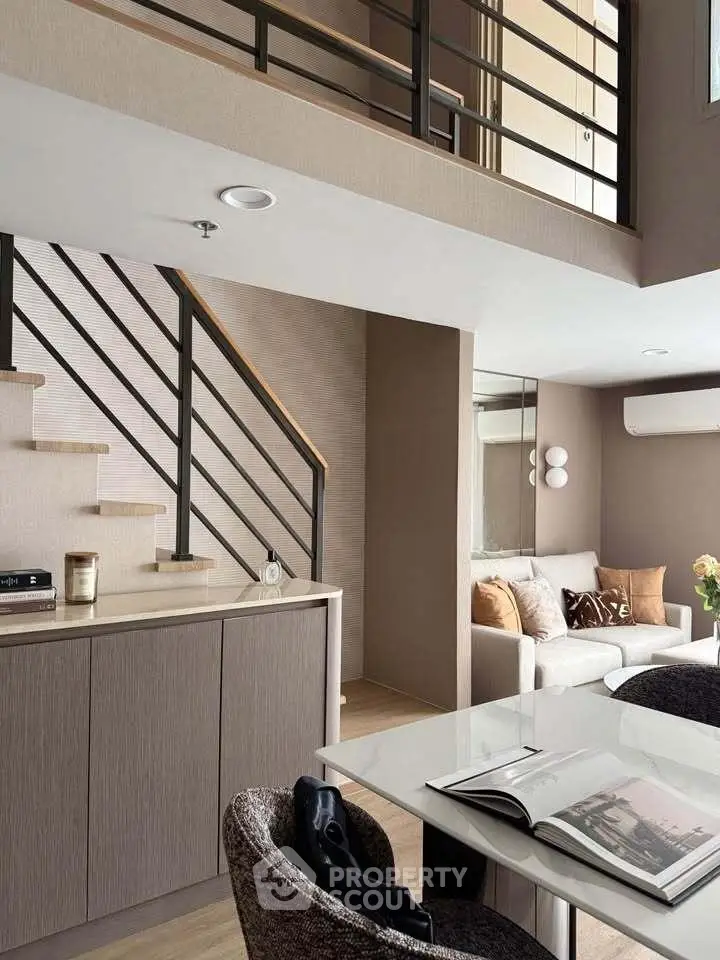 Modern duplex living room with stylish decor and open staircase