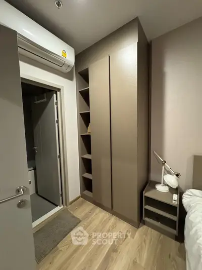 Modern bedroom with sleek storage and air conditioning, perfect for urban living.