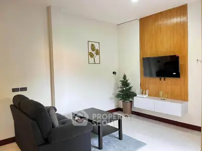 Modern living room with sleek TV setup and cozy sofa