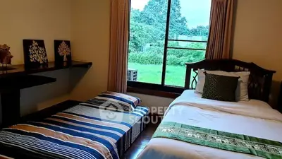 Cozy bedroom with twin beds and scenic window view