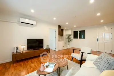 Spacious modern living room with wooden flooring and stylish furniture