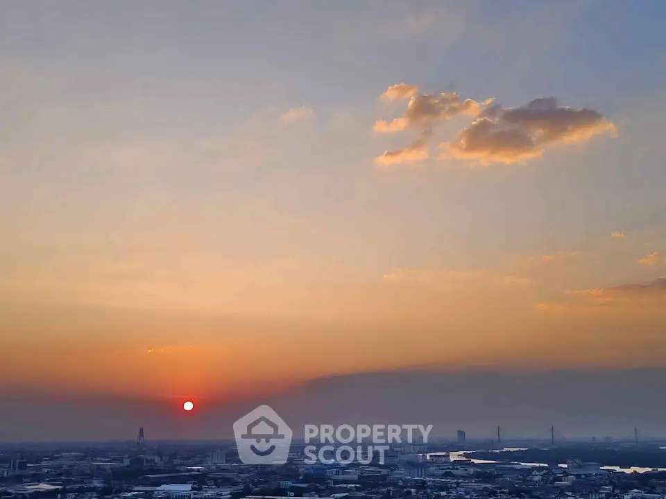 Stunning sunset view over the city skyline with a river and bridges, perfect for urban living enthusiasts.
