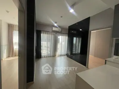 Spacious modern apartment with open layout and large windows for natural light.