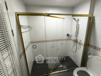 Modern bathroom with glass shower enclosure and stylish tile accents