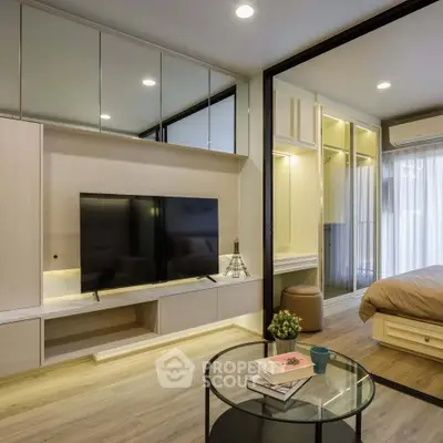 Modern studio apartment with sleek design, featuring a cozy bedroom and stylish living area with TV.
