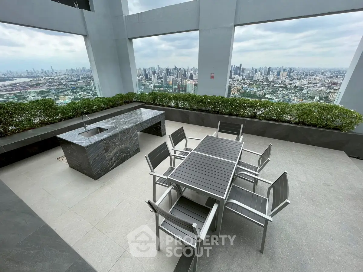 Stunning rooftop terrace with panoramic city views and modern outdoor dining area.