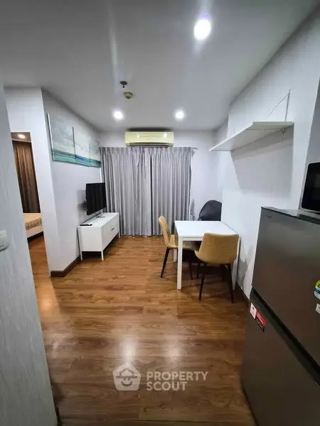 Modern apartment interior with wooden flooring and cozy dining area