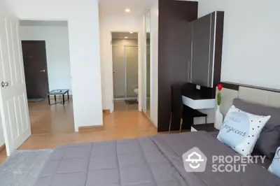 Modern bedroom with stylish decor and ensuite bathroom in a contemporary apartment.