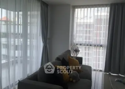 Modern living room with large windows and cozy sofa in a high-rise apartment