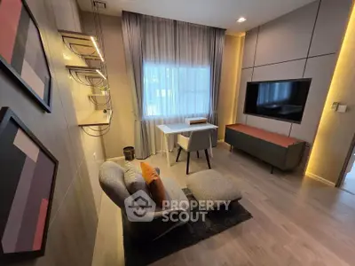 Modern living room with stylish decor, featuring a cozy chair, sleek TV setup, and elegant lighting.