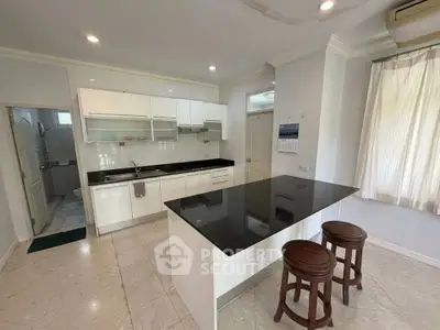 Spacious kitchen with modern black countertop and open layout design
