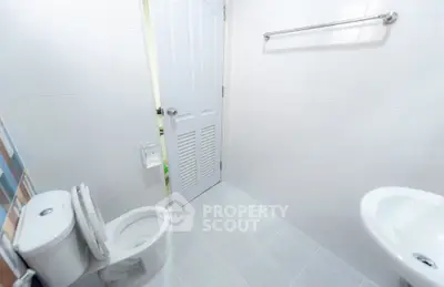 Modern minimalist bathroom with white tiles and sleek fixtures