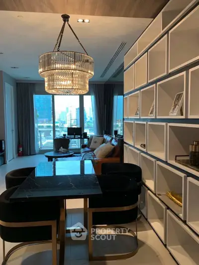 Luxurious modern living room with elegant chandelier and city view, perfect for urban living.