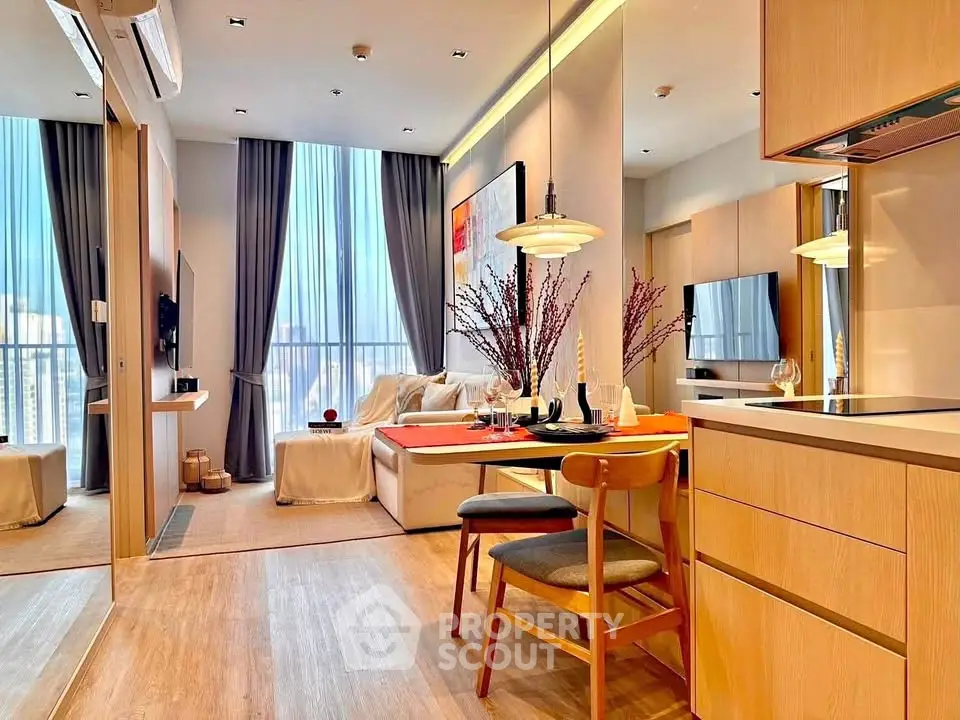 Modern open-plan living and dining area with stylish decor and large windows.