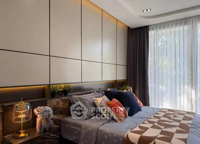 Luxurious bedroom with modern decor and large window offering natural light.