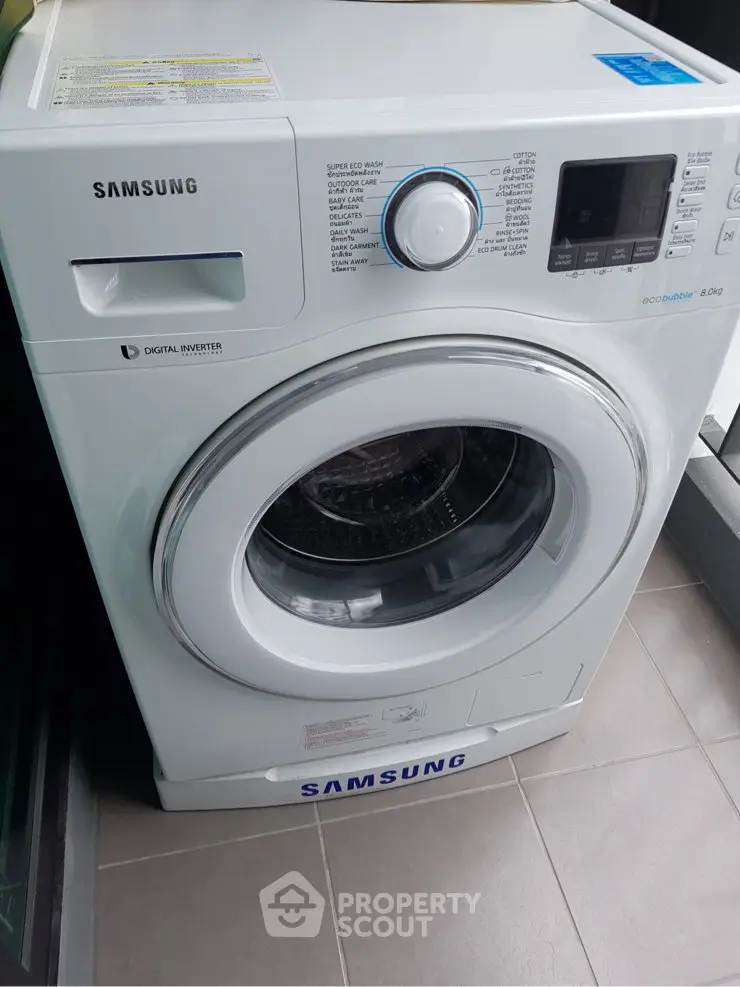Modern Samsung washing machine in sleek laundry area with digital inverter technology.