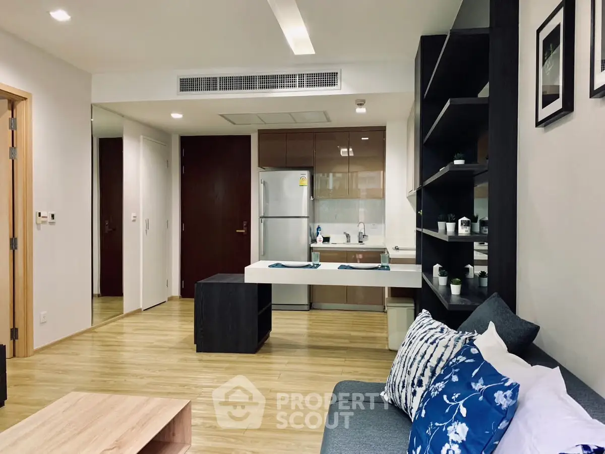 Modern open-plan living room with stylish kitchen and cozy seating area.