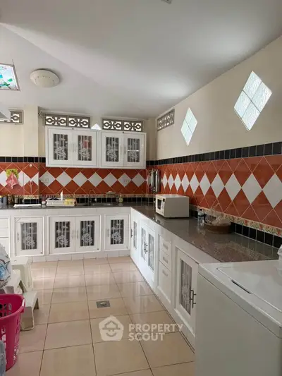 Charming kitchen with unique tile backsplash and ample storage space