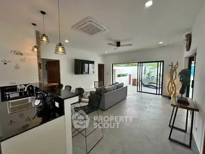 Modern open-plan living room with sleek kitchen and stylish decor
