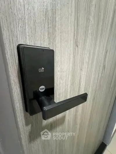 Modern electronic door lock on a stylish wooden door, enhancing security and aesthetics.