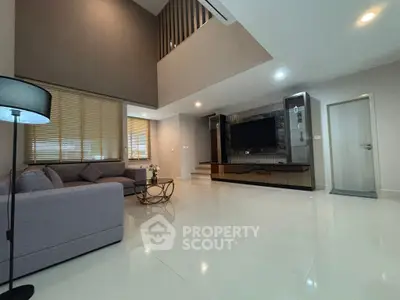 Spacious modern living room with high ceiling and elegant decor