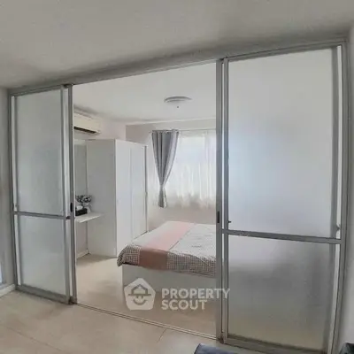 Modern bedroom with sliding glass doors and natural light