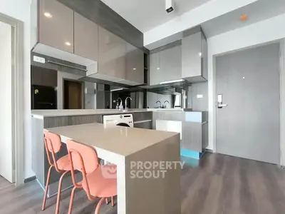Modern kitchen with sleek cabinetry and integrated appliances in a stylish apartment.