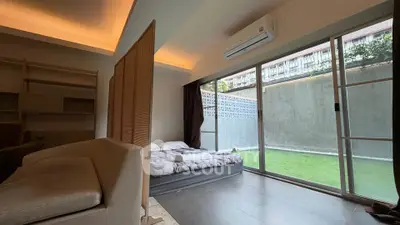 Spacious bedroom with sliding glass doors opening to a private garden area.