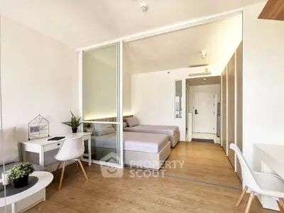 Modern studio apartment with twin beds and stylish decor