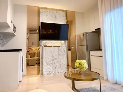 Modern living room with open kitchen, marble accents, and sleek appliances in a stylish apartment.