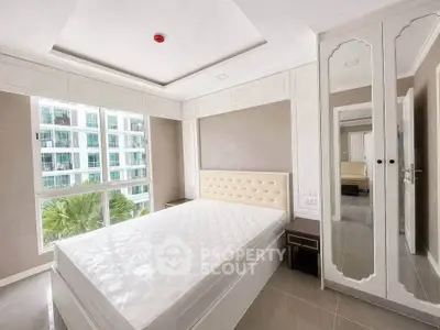 Spacious modern bedroom with large windows and elegant mirrored wardrobe in a luxury apartment.