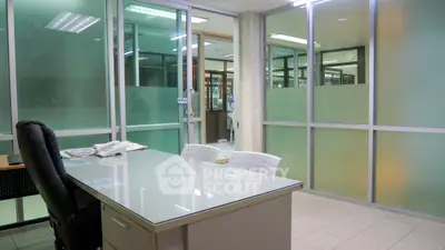 Spacious and well-lit commercial office space with modern glass partitions and ergonomic furniture, ideal for dynamic business operations.