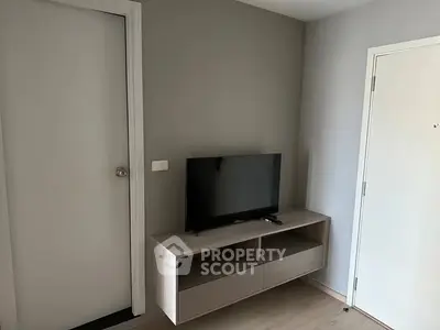 Modern minimalist living room with sleek TV stand and neutral tones.