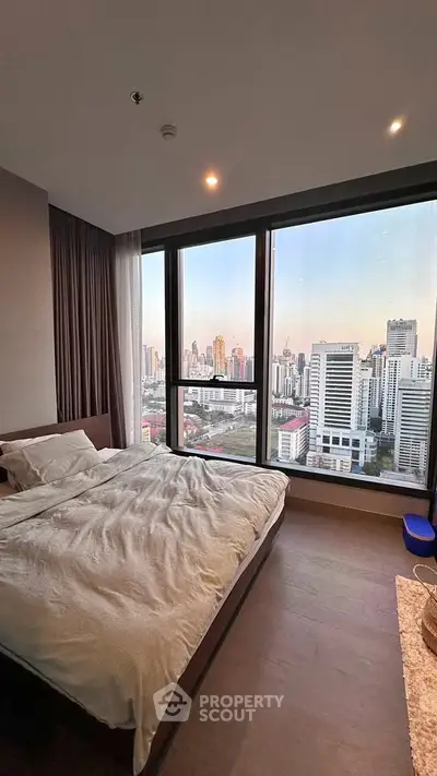 Luxurious bedroom with stunning city skyline view from large windows
