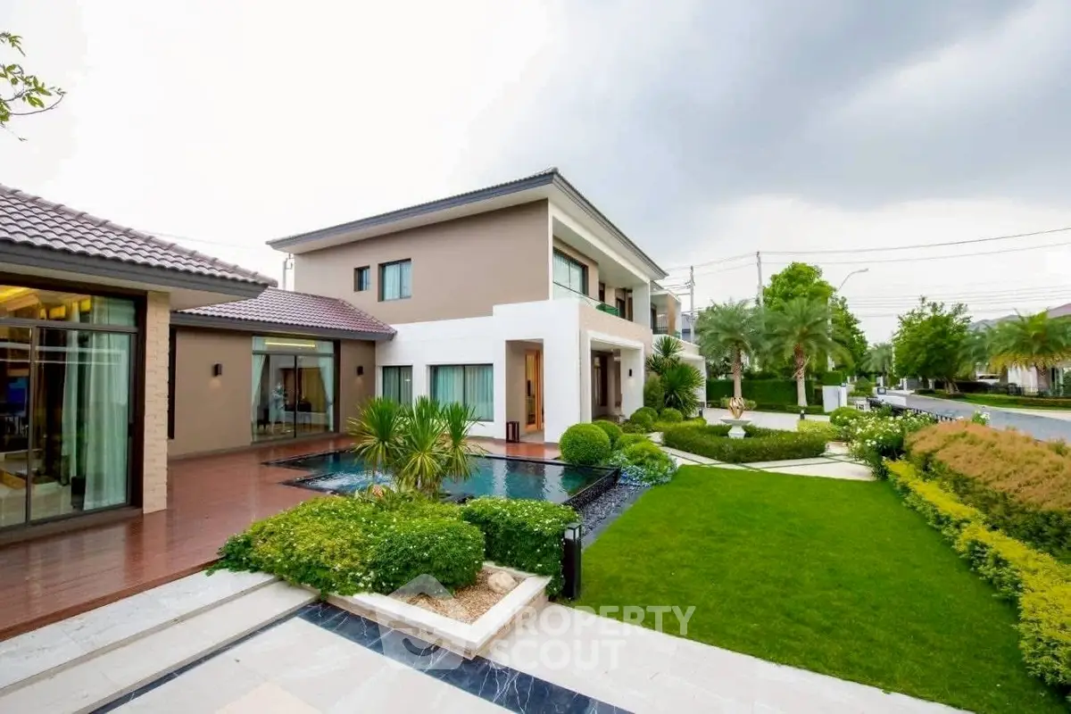Luxurious modern house with landscaped garden and pool in serene neighborhood.