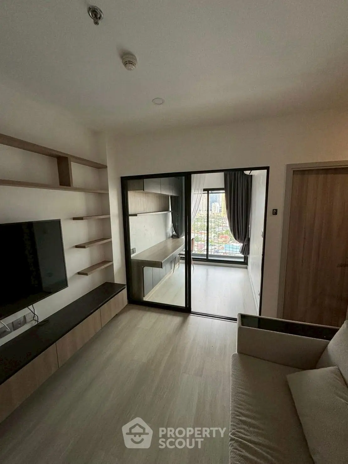 Modern living room with sleek design and large window view