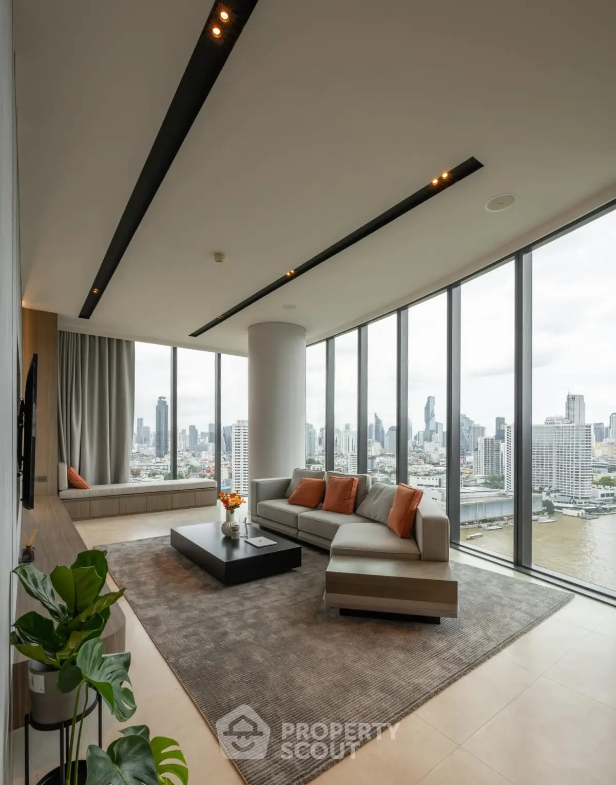 Luxurious corner unit living room with panoramic city views and modern decor.