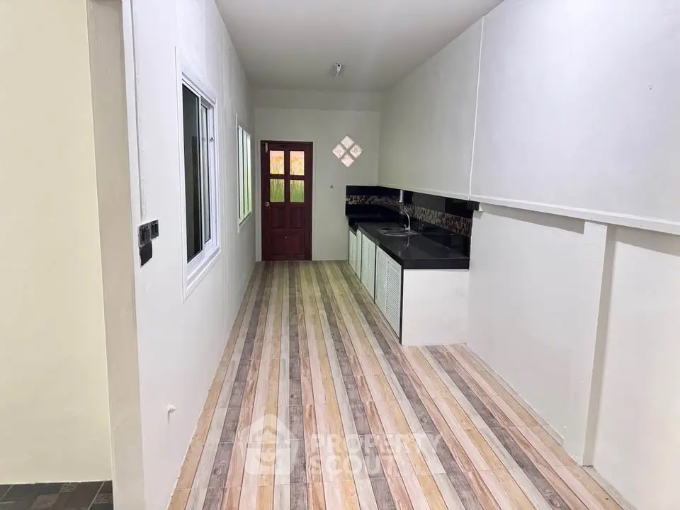 Spacious kitchen with sleek countertops and modern flooring, perfect for culinary enthusiasts.