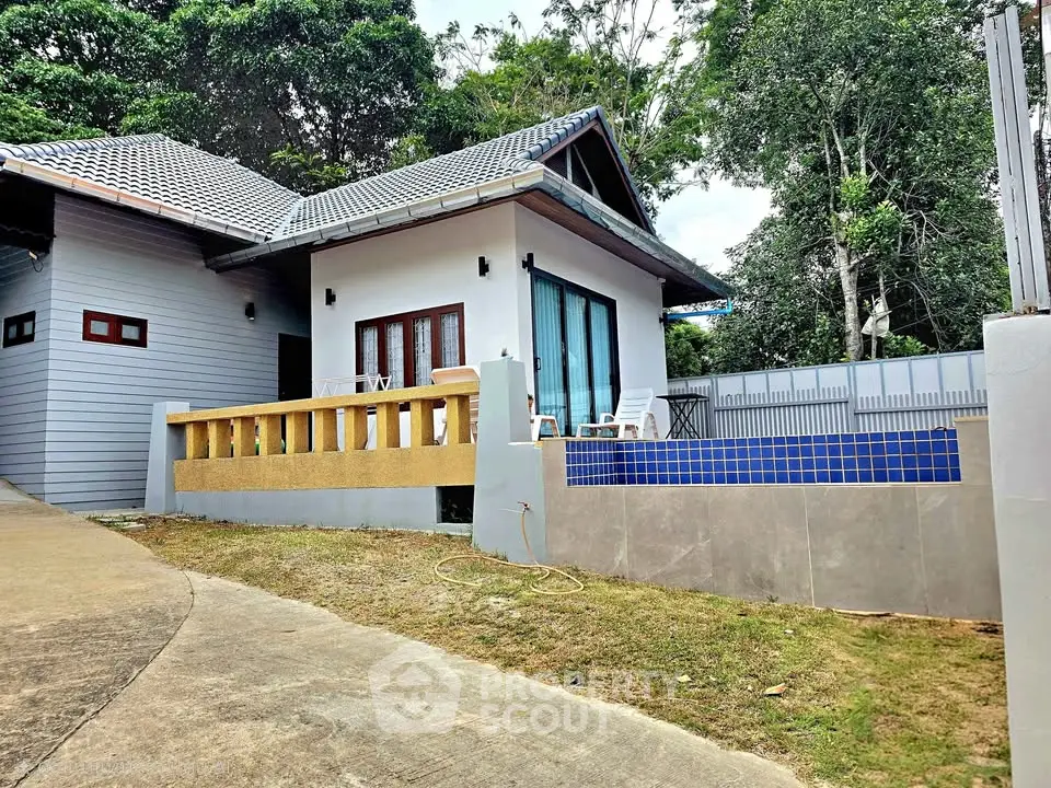 Charming modern house with private pool and lush greenery, perfect for serene living.