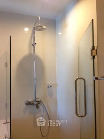 Modern bathroom with glass shower enclosure and sleek fixtures