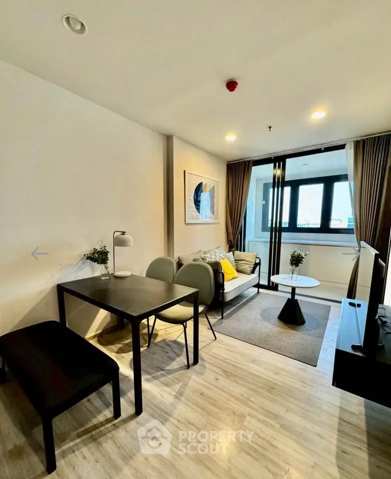 Modern living room with stylish decor and ample natural light in a contemporary apartment.