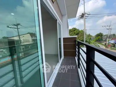 Modern balcony with sleek railing and scenic view of neighborhood